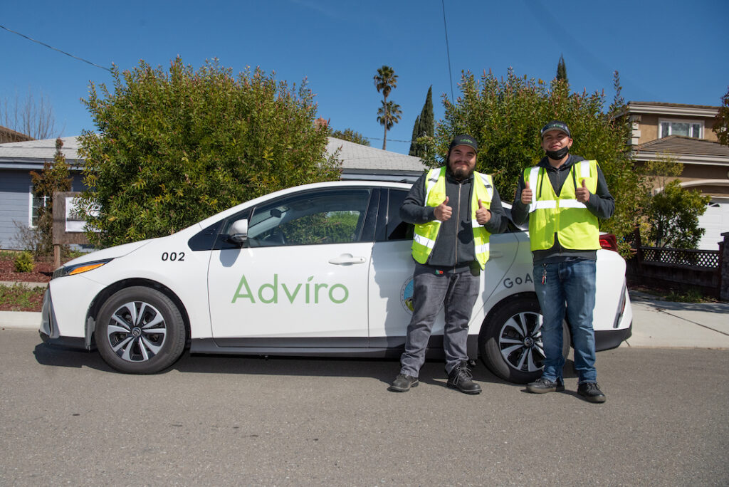 Adviro environmental team stands by the company car after finishing an asbestos survey at a home. 